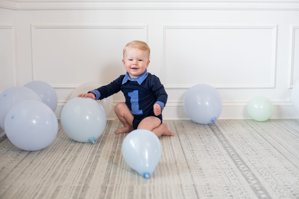 toddler boy with balloons