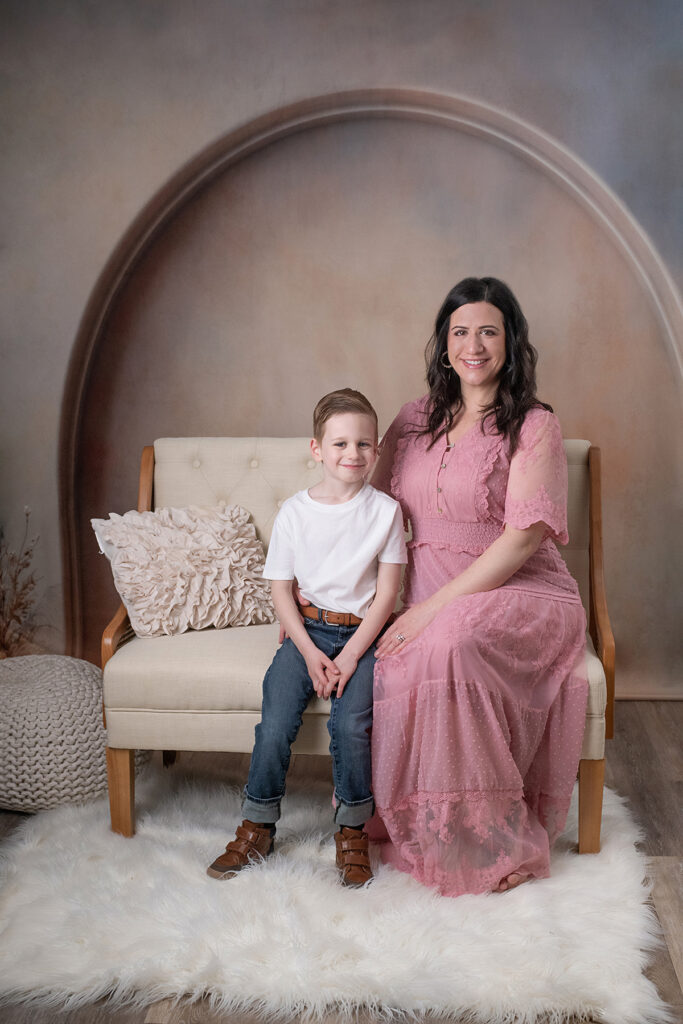Mom posing with her son on a couch mother's day portraits
