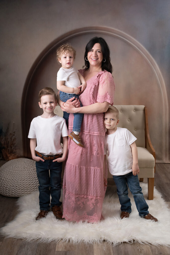 Mom and sons smiling together for mother's day portraits