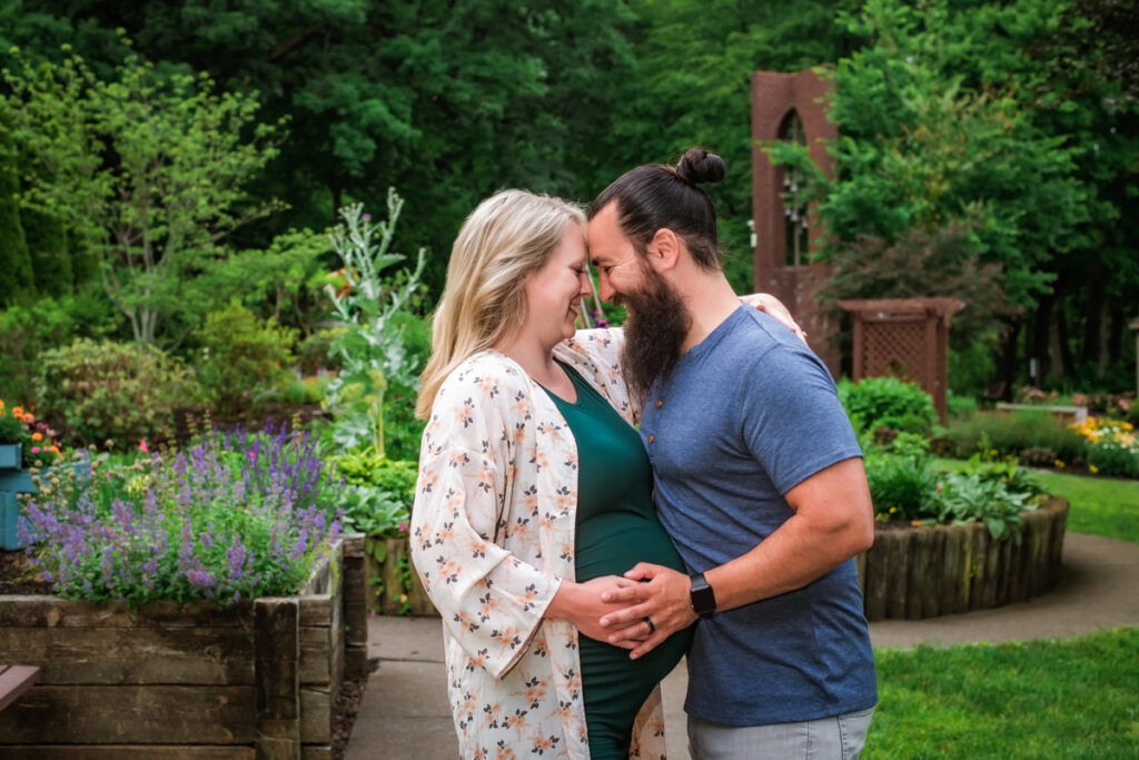 Happy couple embrace at canton garden center gardens for maternity portraits